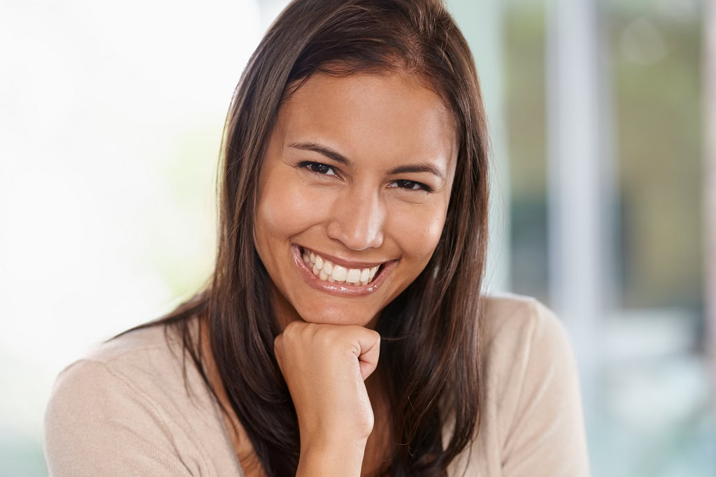 happy-woman-portrait-relax-with-positive-attitude-natural-beauty-living-room-home-face-young-female-person-brunette-model-with-smile-holiday-break-weekend-house