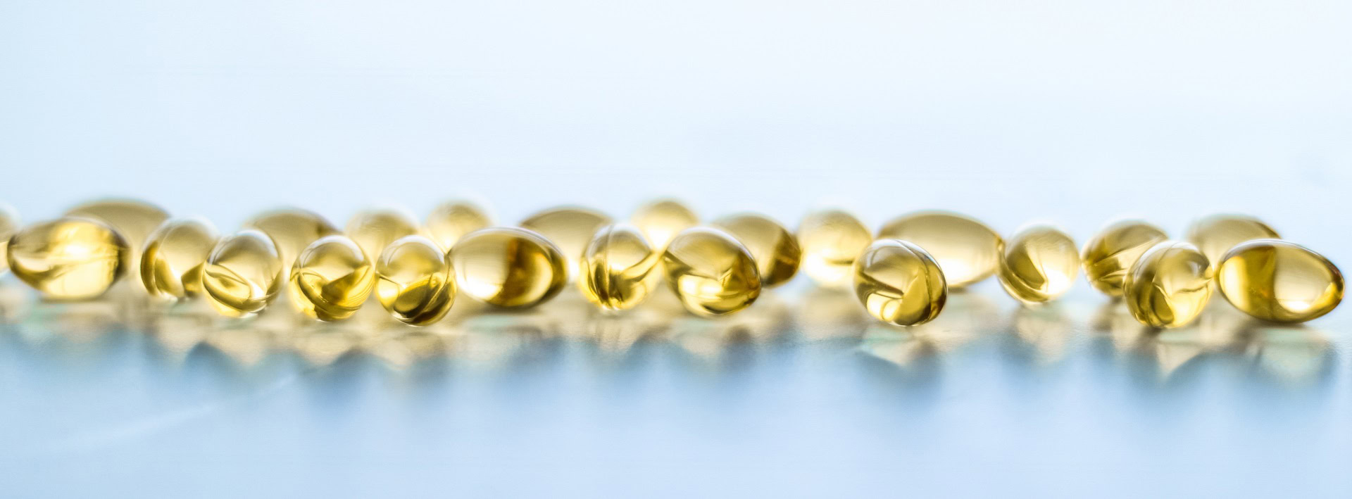 vitamin-d-golden-omega-3-pills-healthy-diet-nutrition-fish-oil-food-supplement-pill-capsules-healthcare-medicine-as-pharmacy-background